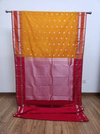 Saffron Yellow Semi Kanchi Saree with Silver Zari & Orange Pallu Design