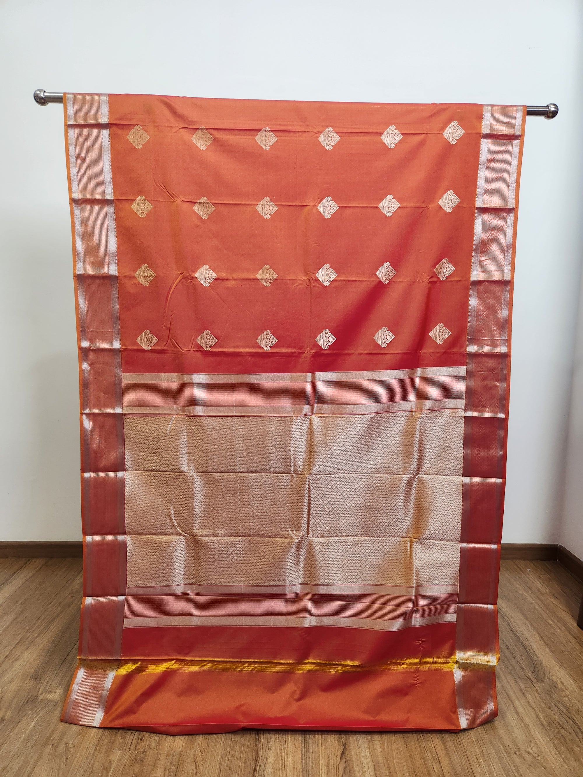 Rust Orange Semi Kanchi Saree with Silver Zari & Flower Butta Design